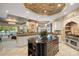 Open concept kitchen features a Wolf range, tile backsplash, and a large island with views of the lake at 18201 Town Harbour Rd, Cornelius, NC 28031