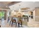 Bright kitchen features a large island with seating, unique lighting, and stainless steel appliances at 18201 Town Harbour Rd, Cornelius, NC 28031
