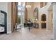 Spacious living room with a grand piano, soaring ceilings, and abundant natural light at 18201 Town Harbour Rd, Cornelius, NC 28031