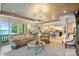 Open-concept living area with a fireplace, comfortable seating, and views of the water at 18201 Town Harbour Rd, Cornelius, NC 28031