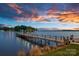 Picturesque pier stretching into calm waters, illuminated by ambient lights under a colorful twilight sky at 18201 Town Harbour Rd, Cornelius, NC 28031