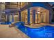 Exterior view of a stunning pool with a bridge, and a large columned patio at 18201 Town Harbour Rd, Cornelius, NC 28031