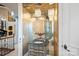 Elegant powder room with ornate mirror, vanity, decorative lighting, and adjacent water closet at 18201 Town Harbour Rd, Cornelius, NC 28031