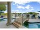 Outdoor pool area featuring a bridge, lounge chairs, and beautiful water views at 18201 Town Harbour Rd, Cornelius, NC 28031