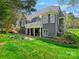 Spacious backyard with a manicured lawn, patio, and lush landscaping, perfect for outdoor living at 19000 Hodestone Mews Ct, Davidson, NC 28036
