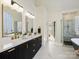 Modern bathroom boasts dual vanities, marble floors, and a glass enclosed shower at 19000 Hodestone Mews Ct, Davidson, NC 28036