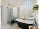 Modern bathroom with marble floors, a glass enclosed shower, and a freestanding tub at 19000 Hodestone Mews Ct, Davidson, NC 28036