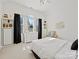 Bright bedroom with a large window, neutral carpet, and contemporary furnishings at 19000 Hodestone Mews Ct, Davidson, NC 28036