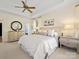 Bright bedroom features a tray ceiling, neutral decor, and large windows at 19000 Hodestone Mews Ct, Davidson, NC 28036