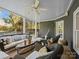 Relaxing covered patio with comfortable seating, ceiling fan, and backyard view, perfect for outdoor enjoyment at 19000 Hodestone Mews Ct, Davidson, NC 28036