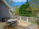 Outdoor deck with dining table, grill, and wooded views, ideal for barbecues and gatherings at 19000 Hodestone Mews Ct, Davidson, NC 28036