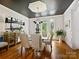 Elegant dining room with a modern chandelier, large windows, and stylish decor at 19000 Hodestone Mews Ct, Davidson, NC 28036