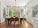 Bright dining room features modern lighting and large windows overlooking the backyard at 19000 Hodestone Mews Ct, Davidson, NC 28036