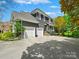 Elegant home featuring a three-car garage, modern exterior, ample parking, and lush landscaping at 19000 Hodestone Mews Ct, Davidson, NC 28036