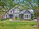 Beautiful two-story home with a blue exterior, well-manicured lawn, and charming curb appeal at 19000 Hodestone Mews Ct, Davidson, NC 28036