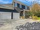 Home exterior featuring 3 car garage and dark gray siding at 19000 Hodestone Mews Ct, Davidson, NC 28036