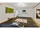 Spacious exercise room with brick wall, wall art, and sliding barn door at 19000 Hodestone Mews Ct, Davidson, NC 28036