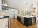 Bright kitchen features stainless steel appliances, a wine fridge and a large center island at 19000 Hodestone Mews Ct, Davidson, NC 28036