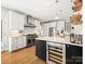 Bright kitchen features stainless steel appliances, a wine fridge and a large center island at 19000 Hodestone Mews Ct, Davidson, NC 28036