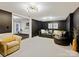 Relaxing living room with black walls, leather seating, and access to adjacent spaces at 19000 Hodestone Mews Ct, Davidson, NC 28036