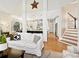Spacious living room with an open layout, seamlessly connected to a modern kitchen and staircase at 19000 Hodestone Mews Ct, Davidson, NC 28036