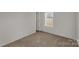 This cozy bedroom has neutral paint, carpet, and one window with blinds at 2005 Sugar Hill Rd, York, SC 29745