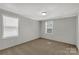 This comfortable bedroom has neutral paint, carpet, and windows with blinds at 2005 Sugar Hill Rd, York, SC 29745