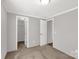 This bedroom has neutral paint, carpet, and two open doors at 2005 Sugar Hill Rd, York, SC 29745