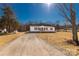 Charming single-story home with a large yard and a long driveway on a bright sunny day at 2005 Sugar Hill Rd, York, SC 29745