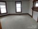 Bright bedroom with natural light from two windows, complemented by a classic fireplace mantel at 201 W Rice St, Landis, NC 28088