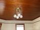 An ornate light fixture hangs from a classic wooden ceiling, creating a vintage aesthetic at 201 W Rice St, Landis, NC 28088