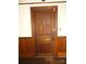 A solid wooden interior door with paneled detailing, set against classic trim and paneled walls at 201 W Rice St, Landis, NC 28088