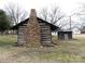Charming log cabin with a unique stone chimney and landscaping at 201 W Rice St, Landis, NC 28088