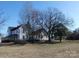 A large farmhouse with mature trees, seen from a grassy yard at 201 W Rice St, Landis, NC 28088