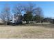 A sprawling farmhouse with mature trees and a large yard at 201 W Rice St, Landis, NC 28088