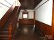 Spacious foyer featuring a grand wooden staircase and traditional wood accents at 201 W Rice St, Landis, NC 28088