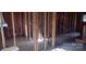 Interior view of a framed room, showcasing plumbing and electrical wiring at 201 W Rice St, Landis, NC 28088