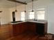 Bright kitchen with an island cooktop, sink, dishwasher, and hardwood floors at 201 W Rice St, Landis, NC 28088