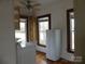 Laundry area features a washer, vintage cabinets, and natural light from multiple windows at 201 W Rice St, Landis, NC 28088