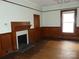 Living room showcasing original hardwood floors, a decorative fireplace, and natural light from a window at 201 W Rice St, Landis, NC 28088