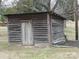 Weathered wood outbuilding, barn or shed on a grassy lot with trees at 201 W Rice St, Landis, NC 28088