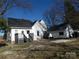 Backyard view features a deck with stairs plus outbuilding with matching trim and roof at 201 W Rice St, Landis, NC 28088