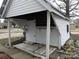 Small white shed with a sheltered entrance and weathered wooden planks at 201 W Rice St, Landis, NC 28088