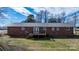 Backyard view of brick home with metal roof and wooden deck at 2028 Hendil St, Conover, NC 28613