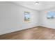 Sunlit bedroom featuring new wood floors, and two large windows overlooking the front yard at 2028 Hendil St, Conover, NC 28613
