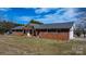 Charming brick home with a metal roof and well-maintained front yard at 2028 Hendil St, Conover, NC 28613