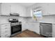 Modern white kitchen featuring new stainless steel appliances and subway tile backsplash at 2028 Hendil St, Conover, NC 28613