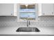 Close up of stainless steel sink area with subway tile and a view of the outdoors at 2028 Hendil St, Conover, NC 28613