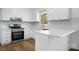 Modern white kitchen featuring new stainless steel appliances and subway tile backsplash at 2028 Hendil St, Conover, NC 28613