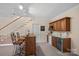 Basement wet bar with seating and stainless steel wine cooler at 213 Patternote Rd, Mooresville, NC 28117